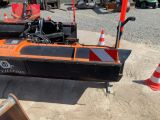 an orange and black boat sitting in the sand