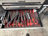 a man standing in front of a tool drawer full of tools