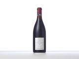 a bottle of red wine sitting on top of a table
