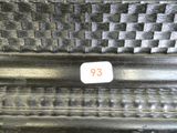 a close up of a metal bench with a number on it