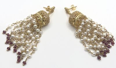 pair of earrings with pearls and garnets on a white background