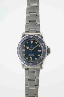 a close up of a wrist watch with a blue dial