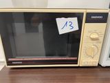 a microwave that is sitting on a table with a price tag on it