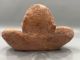 a clay figurine of a man sitting on a table