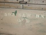 an old wooden box with writing on the side of it