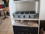a shelf with pots and pans on top of it