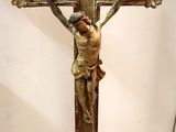 statue of jesus on the cross on a pedestal in a room