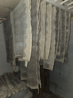 several pieces of cloth hanging from a rack in a room