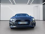 the front view of a blue audi car in a white room