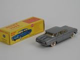 a small toy car next to a box of toys