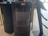 two black refrigerators in the middle of a room