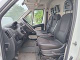 the interior of a white van with four seats and a steering wheel