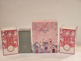 three boxes of perfume sitting next to each other on a white surface