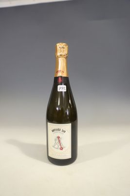 an empty bottle of wine sitting on top of a white table