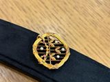 a close up of a black belt with a gold buckle on it