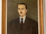 a painting of a man in a suit and tie hanging on a wall