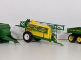 five toy tractors and a trailer on a white surface