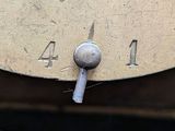a close up of a metal clock with numbers on it