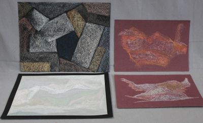three cards with different designs on them sitting on a table
