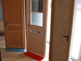 two wooden doors that are open in a room