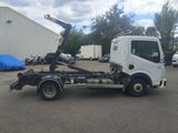 a white truck with a crane attached to it in a parking lot
