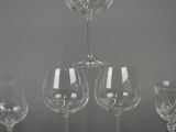 four wine glasses sitting on top of each other on a table