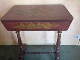 a small table with a wooden top and ornate carvings on it