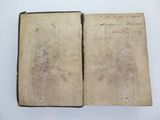 an old book with writing on it sitting on top of a table