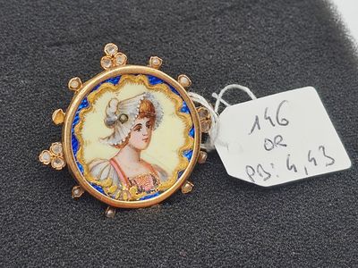 a close up of a necklace with a picture of a woman on it