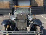an image of an old car parked in a parking lot