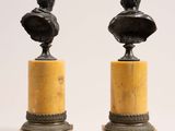 pair of bronze busts of men on marble bases