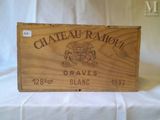 an old wooden crate with a label on it sitting on a table