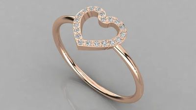 a rose gold ring with a heart shaped diamond set in the center