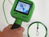 a person holding a green object with a picture on it