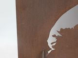 a close up of a metal sculpture with a feather on it