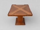 a wooden table with a square top on a pedestal