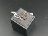 pair of silver plated cufflinks in a box on a black surface