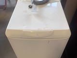 a white refrigerator sitting in the middle of a room