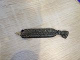 a small black piece of fabric on a wooden table