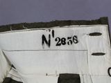 a close up of a white and black jacket with a name on it