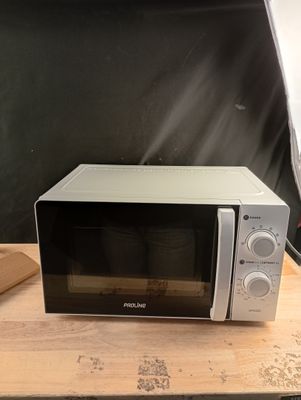 a microwave that is sitting on a wooden table