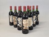 six bottles of wine are lined up in a row on a table