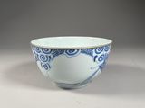 a blue and white bowl sitting on top of a table
