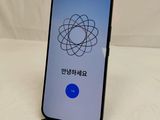 a close up of a cell phone on a table with a logo on the screen
