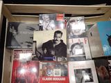 a wooden box filled with various cd ' s and cds