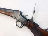 a close up of a rifle on a white surface
