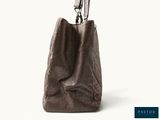 an image of a brown handbag with a silver handle