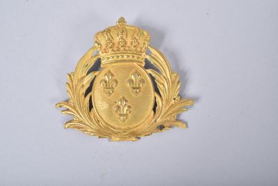 une image représentant un insigne de couleur dorée orné d'une couronne