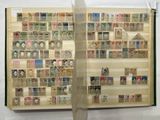 an open book with stamps on it on display