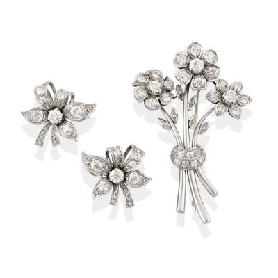 two diamond flower brooches and a pair of earrings
